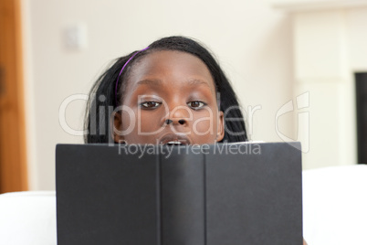 Concentrated woman studying sitting on a sofa