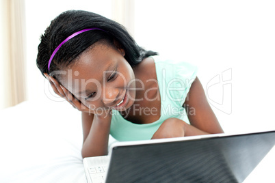 Happy teen girl surfing the internet