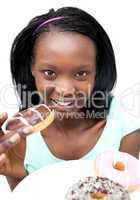 Afro-American young woman eating a chocolate donut