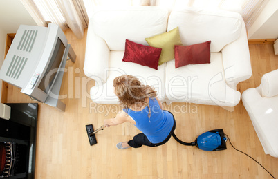 High angle of a blond woman vacuuming