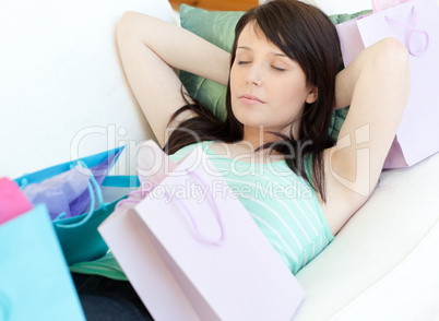 Tired young woman relaxing after shopping
