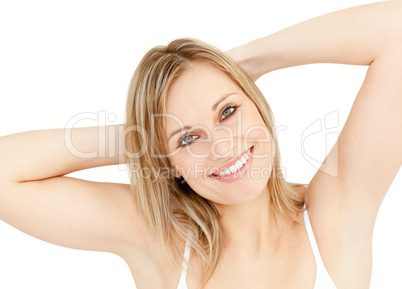 Bright woman stretching sitting on her bed
