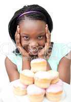 Cheerful young woman looking at cakes