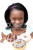 Charming young woman looking at donuts
