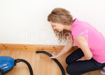 Portrait of a charming woman vacuuming