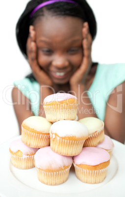 Jolly young woman looking at cakes