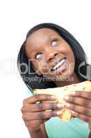 Jolly young woman eating a sandwich