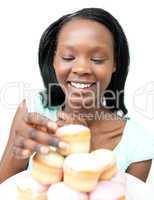 Delighted young woman looking at cakes