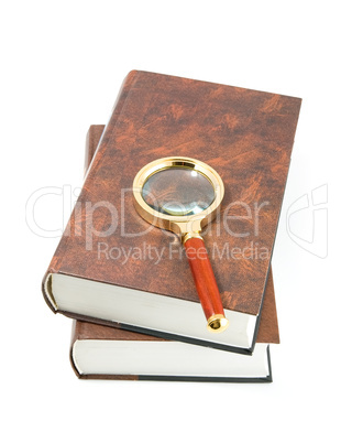 Magnifying glass on books.