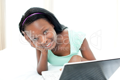 Jolly teen girl surfing the internet