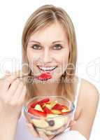 Young woman eating a fruit salad