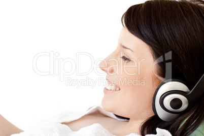 Joyful young woman listening music with headphones
