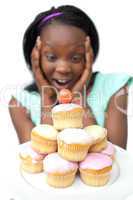 Astonished young woman looking at cakes