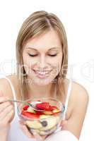Attractive woman eating a fruit salad
