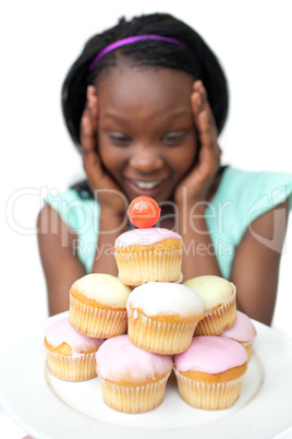 Surprised young woman looking at cakes