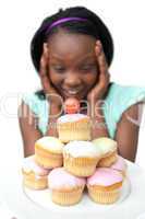 Surprised young woman looking at cakes