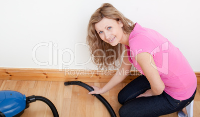 Portrait of a jolly woman vacuuming