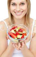 Happy woman holding a fruit salad