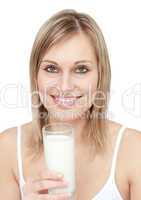 Smiling woman holding a glass of milk