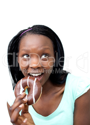 Cheerful young woman eating a chocolate donut