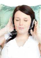 Relaxed young woman listening music with headphones