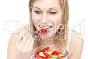 Beautiful woman eating a fruit salad