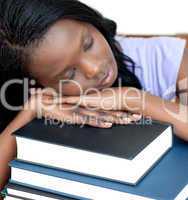 Exhausted student leaning on a stack of books
