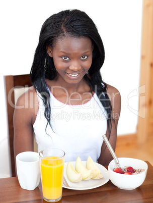 Happy woman having an healthy breakfast