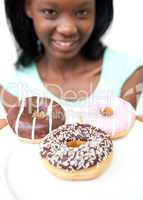 Smiling young woman looking at donuts