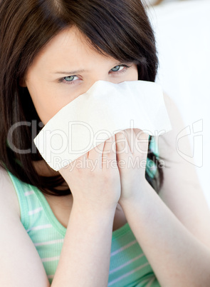Portrait of a sick caucasian teen girl blowing