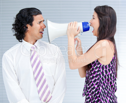 Furious businesswoman yelling through a megaphone