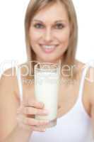 Blond woman holding a glass of milk