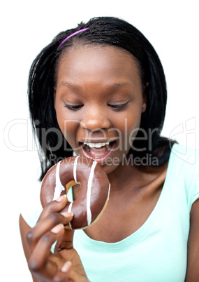 Jolly young woman eating a chocolate donut