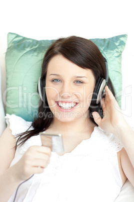 Happy young woman listening music with headphones
