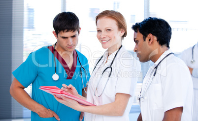 Cheerful female doctor working with her team
