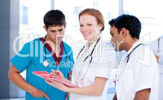 Cheerful female doctor working with her team