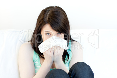 Portrait of a sick attractive woman blowing