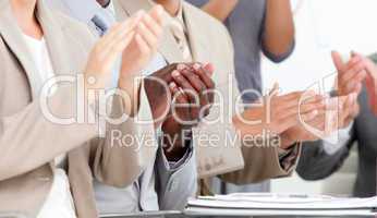 Close-up of business people applauding in a meeting