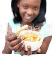Pretty young woman eating fries