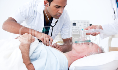 Serious doctor resuscitating a patient