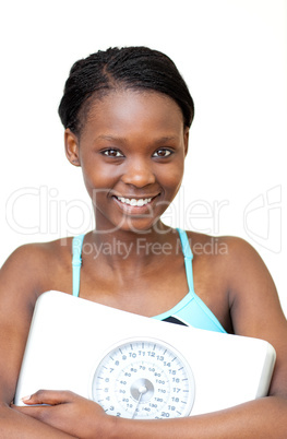 Happy fitness woman holding a weight scale