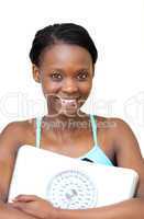 Happy fitness woman holding a weight scale