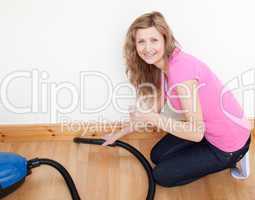 Portrait of a cheerful woman vacuuming