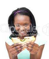 Joyful young woman eating a sandwich