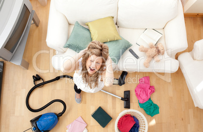 Stressed blond woman vacuuming the living-room