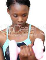 Serious woman working out with dumbbell