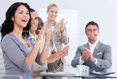 Cheerful business people applauding in a meeting