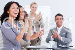 Cheerful business people applauding in a meeting