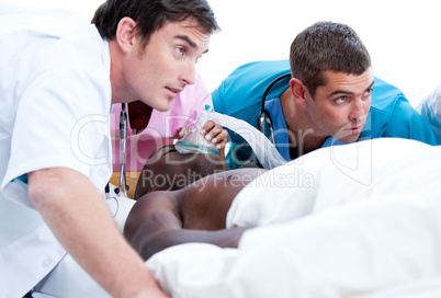 Concentrated medical team resuscitating a patient