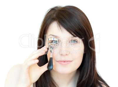 Cute teen girl using an eyelash curler